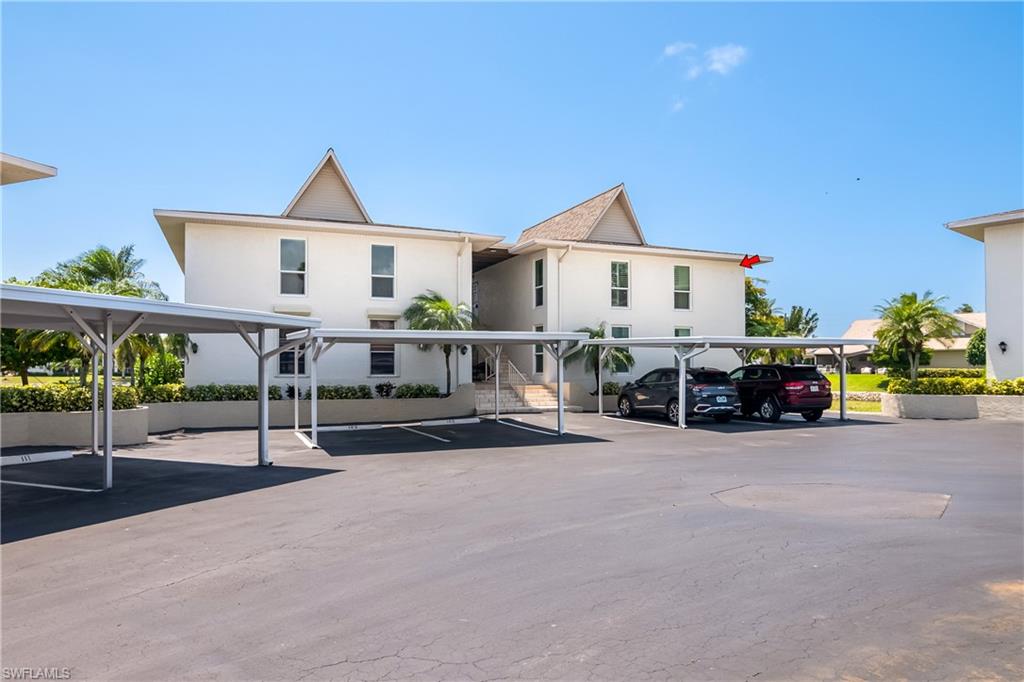 105 Georgetown Boulevard, Unit 105 Naples, FL 34112 - Photo 25 of 28 a view of a house with cars parked