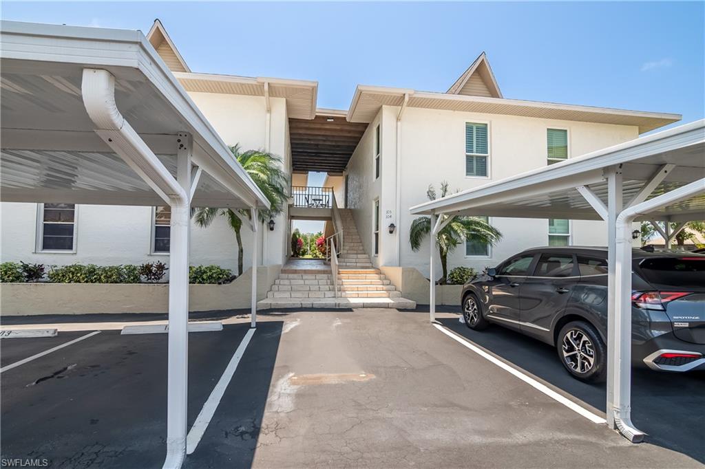 105 Georgetown Boulevard, Unit 105 Naples, FL 34112 - Photo 26 of 28 a view of a car park in front of house