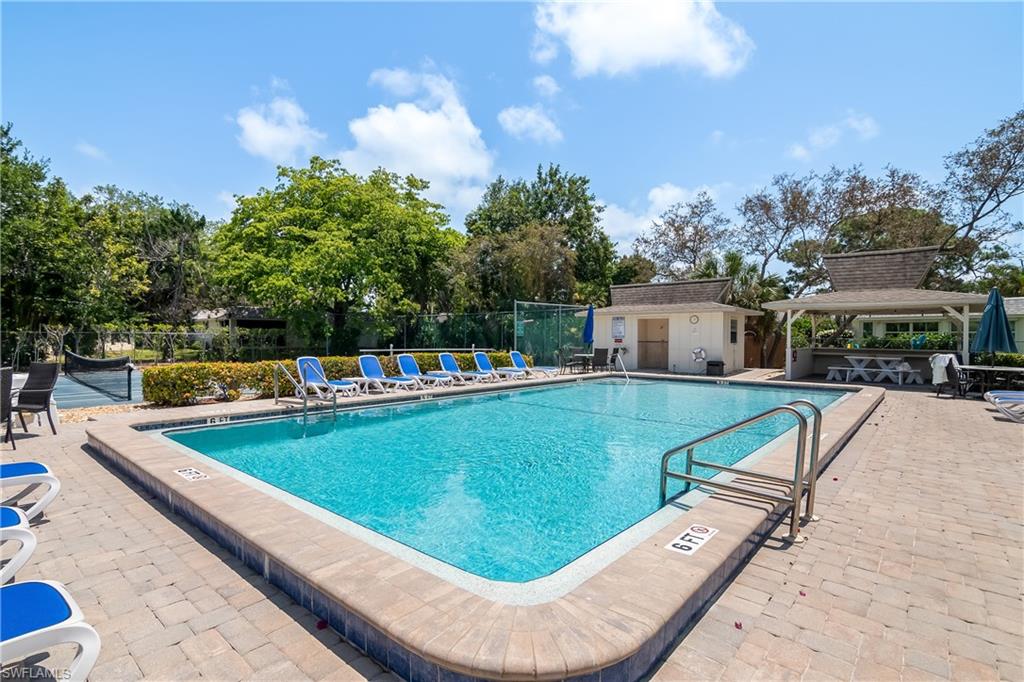 105 Georgetown Boulevard, Unit 105 Naples, FL 34112 - Photo 27 of 28 a view of a swimming pool with a patio