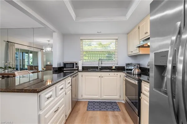 a kitchen with a sink stove and refrigerator