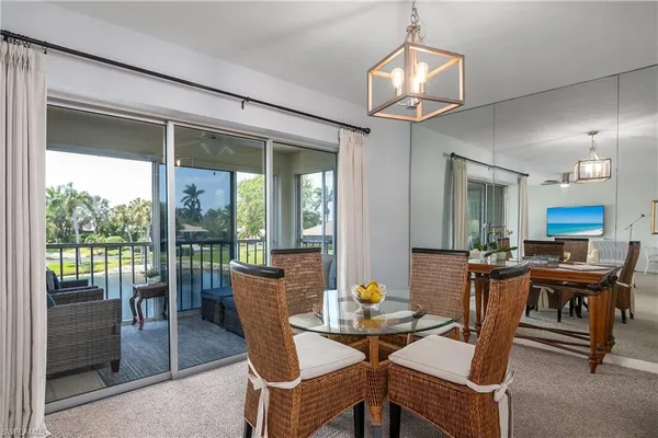 a view of a dining room with furniture wooden floor and chandelier