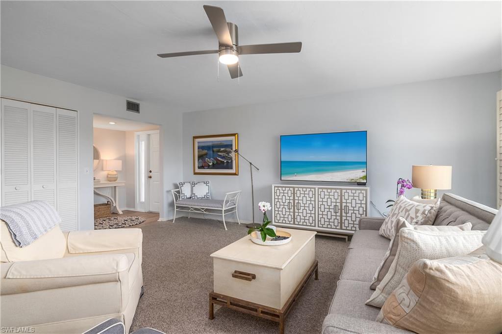 105 Georgetown Boulevard, Unit 105 Naples, FL 34112 - Photo 10 of 28 a living room with furniture and a couch