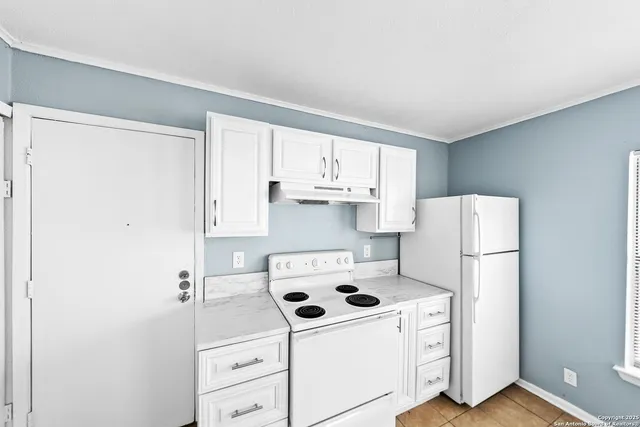 a white refrigerator freezer sitting inside of a kitchen