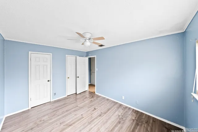 a view of an empty room with wooden floor