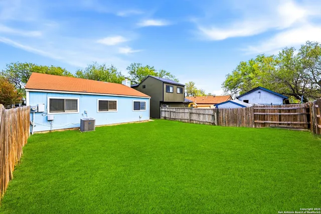 a view of house with backyard and garden