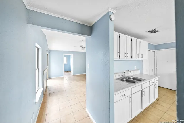a kitchen with stainless steel appliances kitchen island sink refrigerator and cabinets