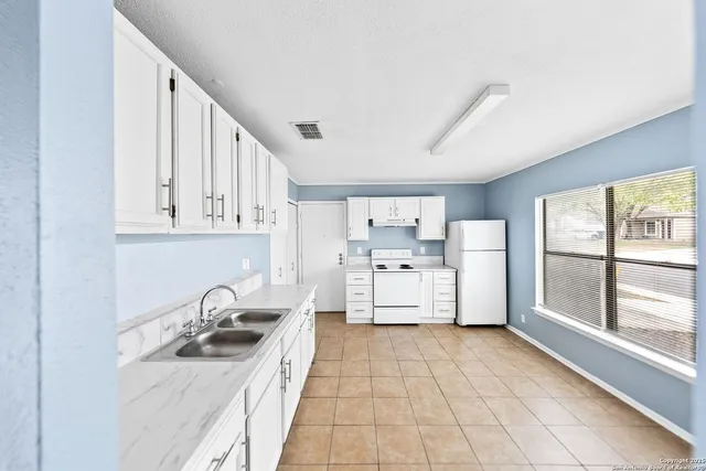a kitchen with stainless steel appliances granite countertop a sink and cabinets