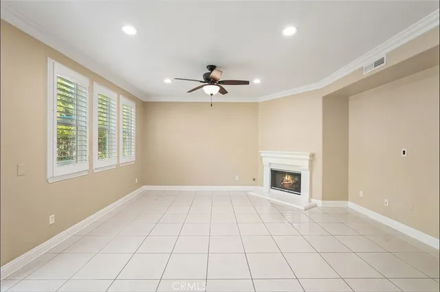 a view of an empty room with a fireplace and a window