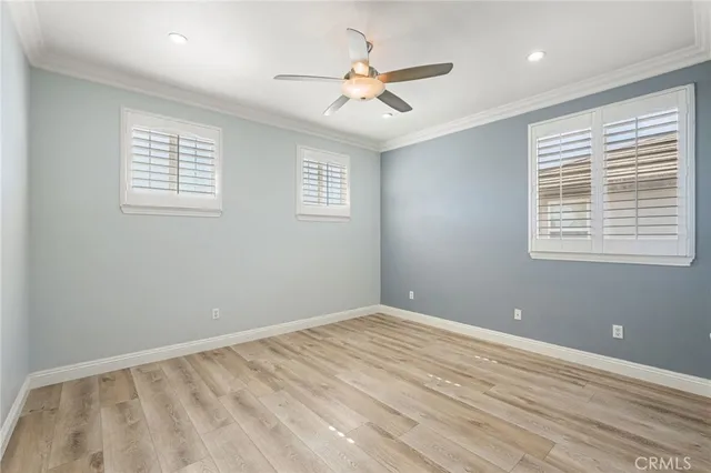 a view of a room with a ceiling fan and a window