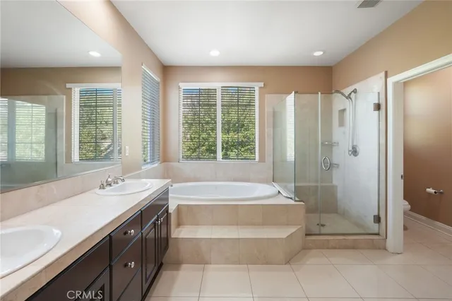 a spacious bathroom with a tub shower and sink