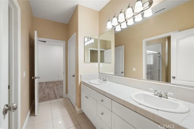 a spacious bathroom with a double vanity sink mirror and double