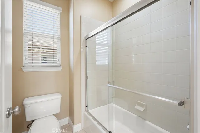 a white toilet sitting next to a bath tub