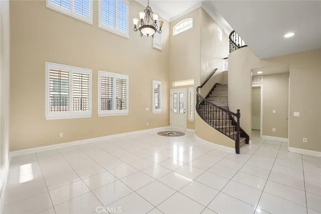 a view of an entryway with wooden floor and a chandelier