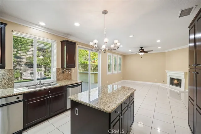 a kitchen with granite countertop sink stove and refrigerator