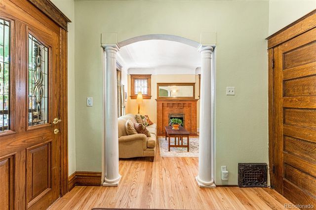 a view of a livingroom with wooden floor and furniture