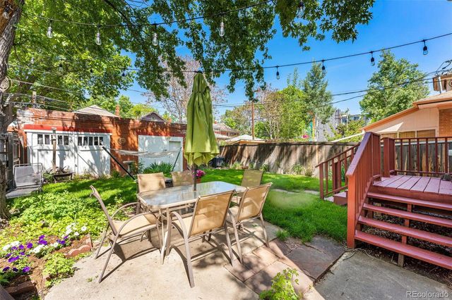 a view of a backyard with sitting area