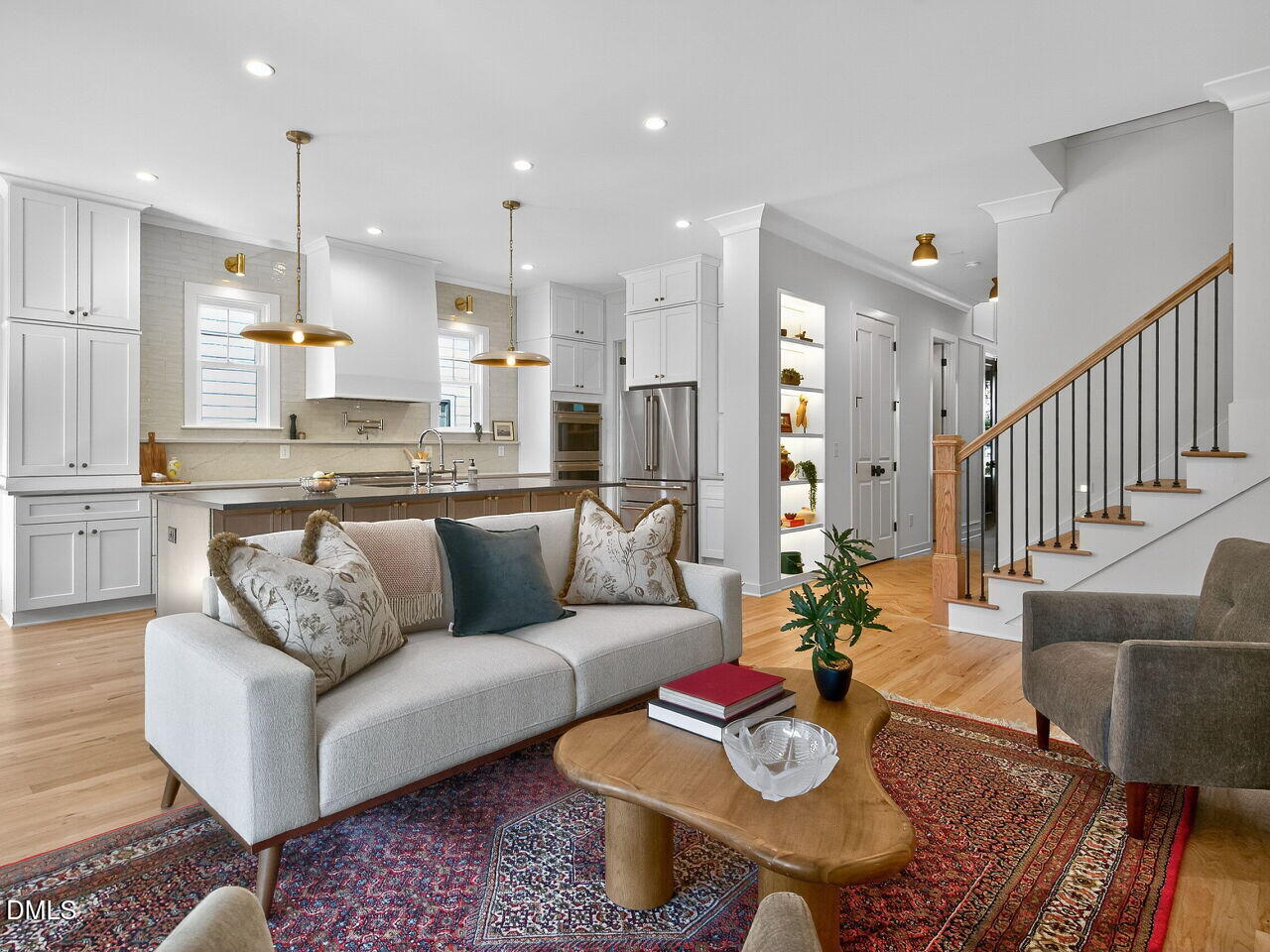 208 East Whitaker Mill Road Raleigh, NC 27608 - Photo 11 of 52 a living room with furniture kitchen view and a wooden floor