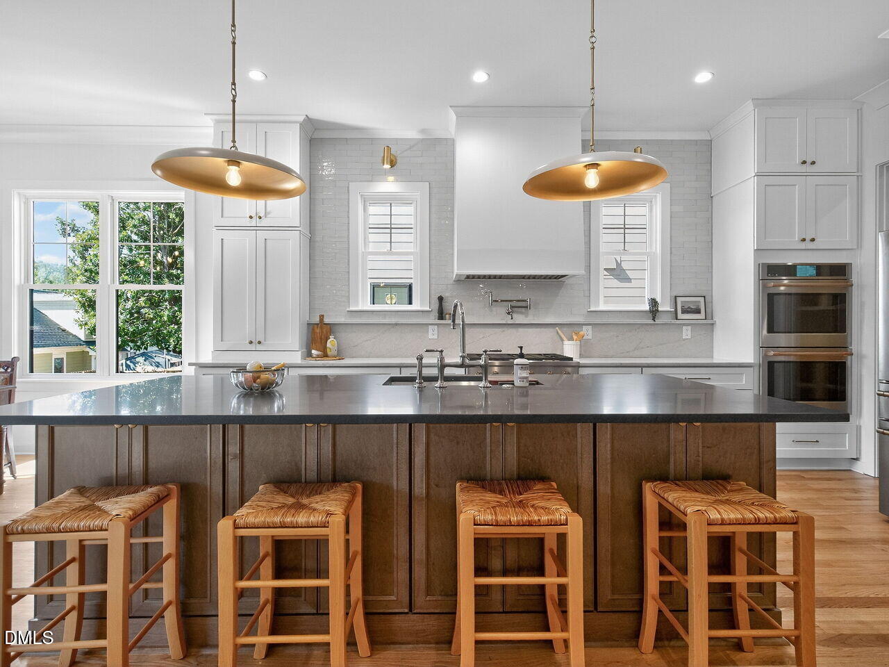 208 East Whitaker Mill Road Raleigh, NC 27608 - Photo 17 of 52 a kitchen with a dining table chairs sink and microwave