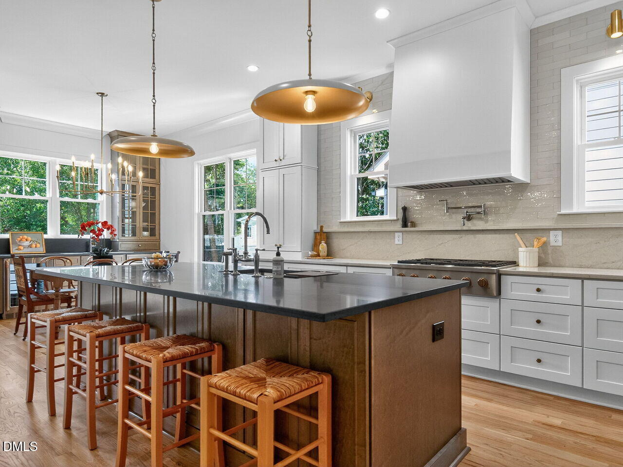 208 East Whitaker Mill Road Raleigh, NC 27608 - Photo 18 of 52 a kitchen with stainless steel appliances granite countertop a stove a sink a dining table and chairs
