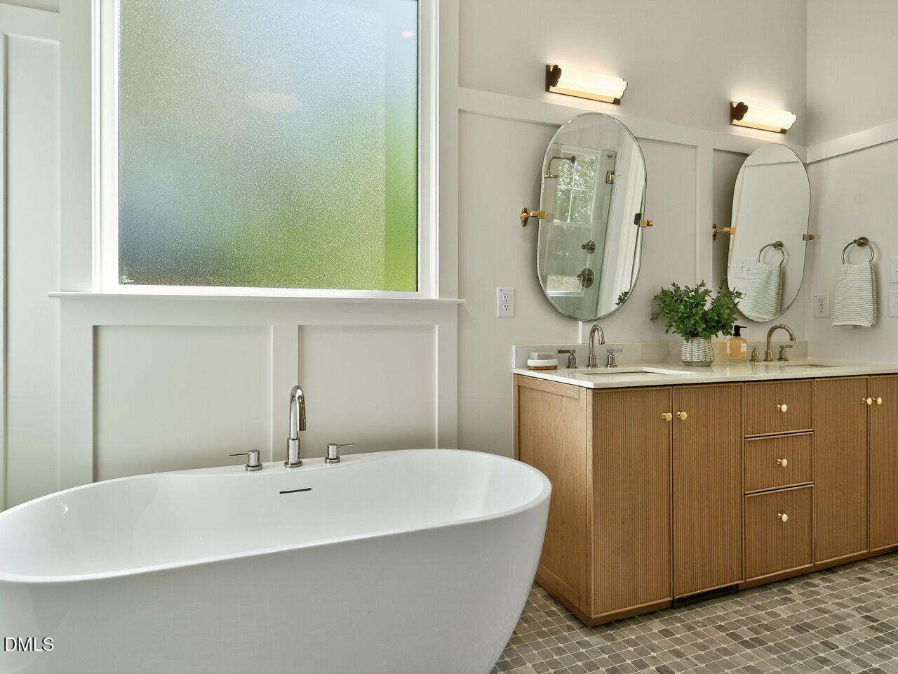 208 East Whitaker Mill Road Raleigh, NC 27608 - Photo 24 of 52 a bathroom with a sink and a mirror