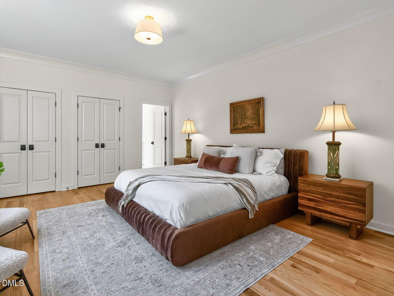 208 East Whitaker Mill Road Raleigh, NC 27608 - Photo 32 of 52 a spacious bedroom with a bed and a lamp
