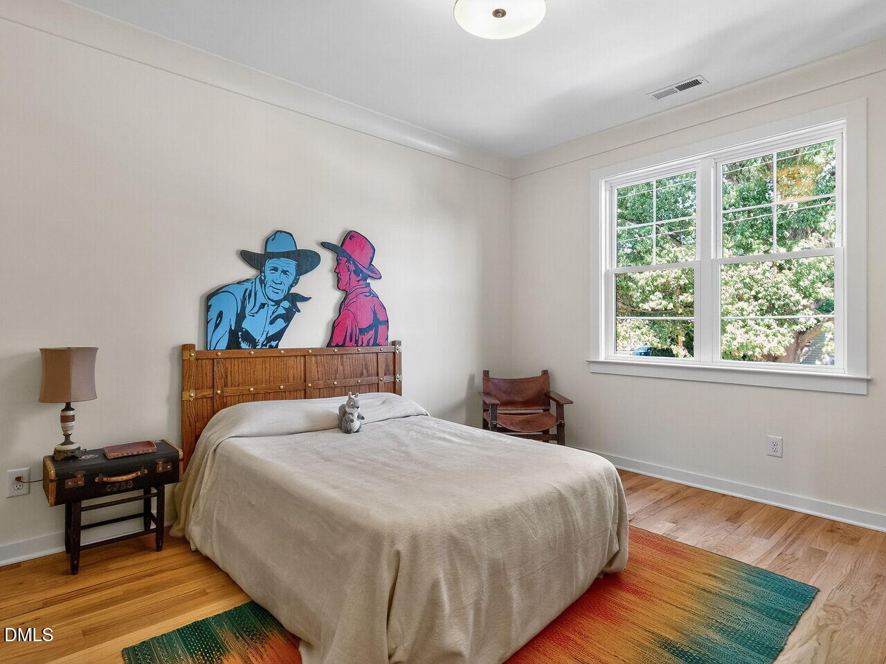 208 East Whitaker Mill Road Raleigh, NC 27608 - Photo 39 of 52 a bedroom with a bed and a painting on the wall