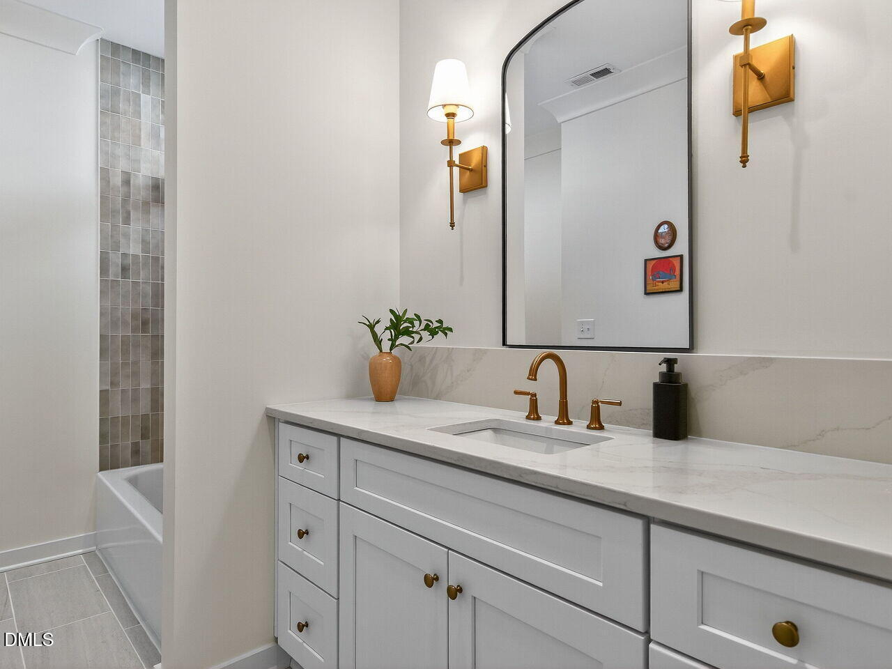 208 East Whitaker Mill Road Raleigh, NC 27608 - Photo 40 of 52 a bathroom with a granite countertop sink and a mirror