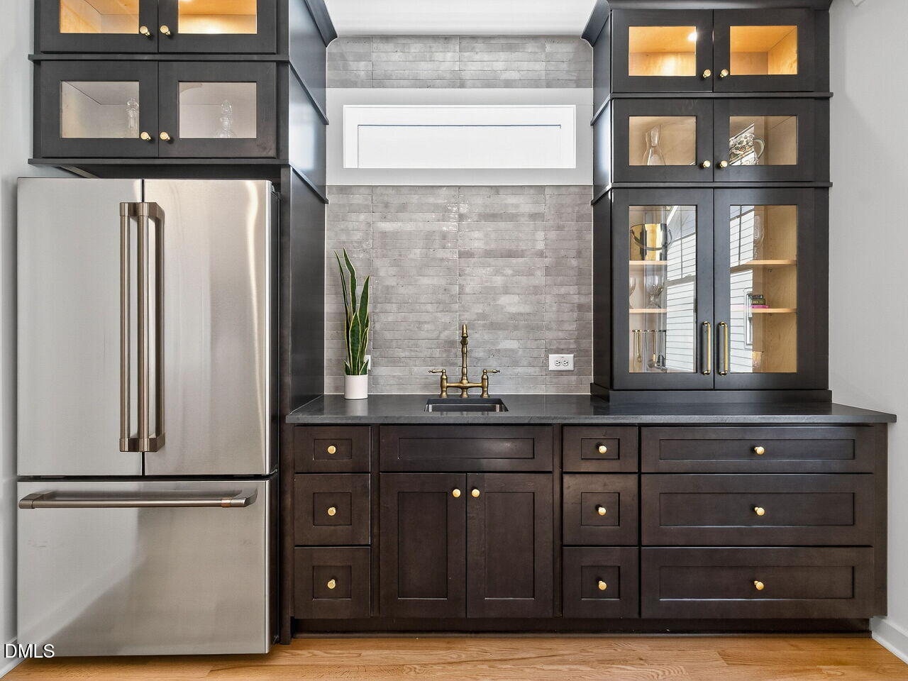 208 East Whitaker Mill Road Raleigh, NC 27608 - Photo 47 of 52 a kitchen with a wooden floor and a window