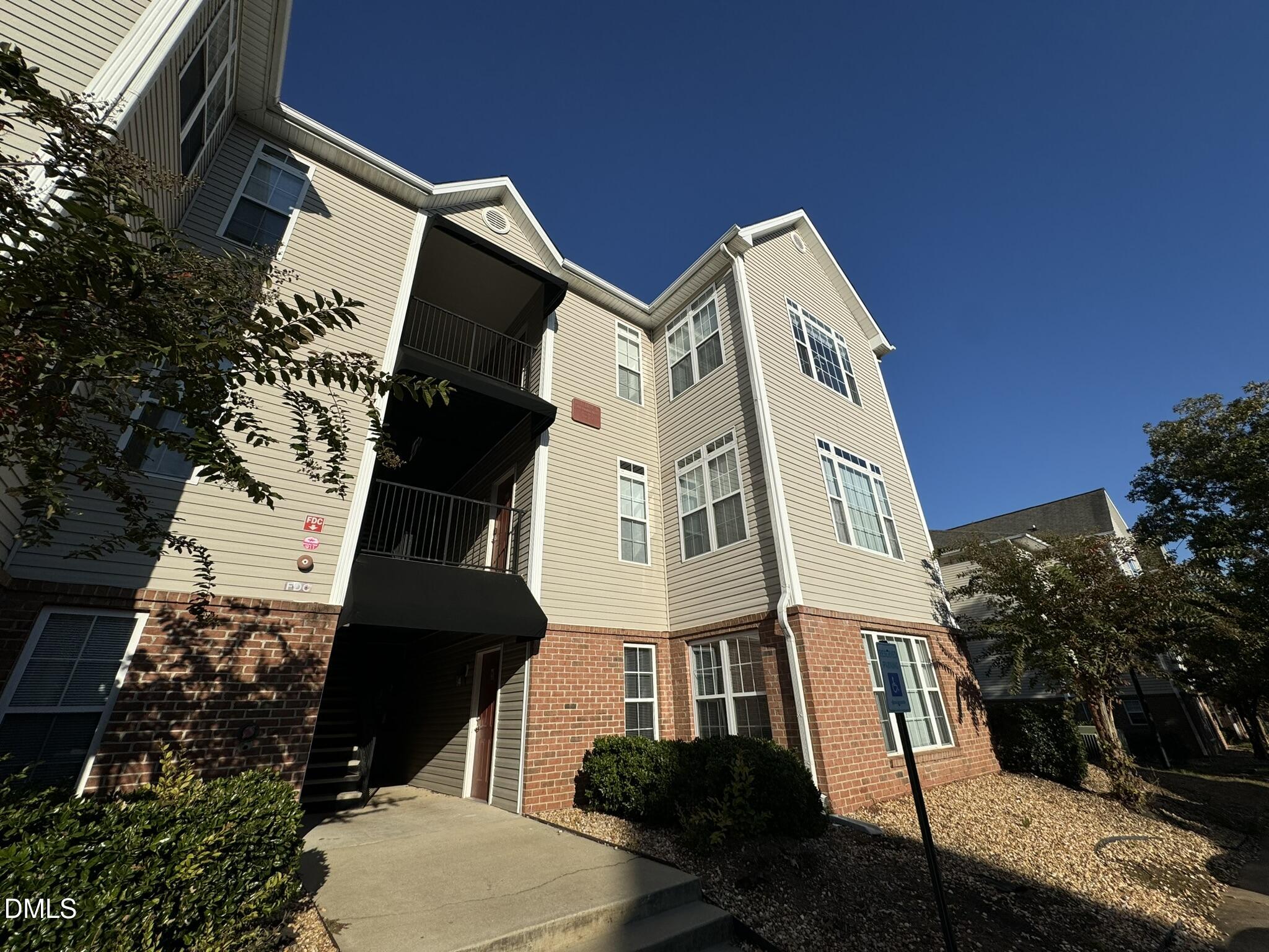 a view of a large building with many windows and yard view