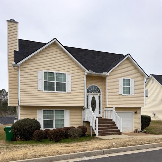 4744 Golod Way Lithonia, GA 30038 - Photo 1 of 1 a front view of a house with a yard and garage