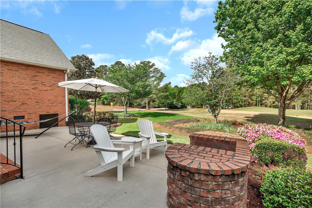 3108 Cobbs Way Anderson, SC 29621 - Photo 5 of 44 Enjoy outdoor living with a spacious patio, lush landscaping, and a scenic golf course view.