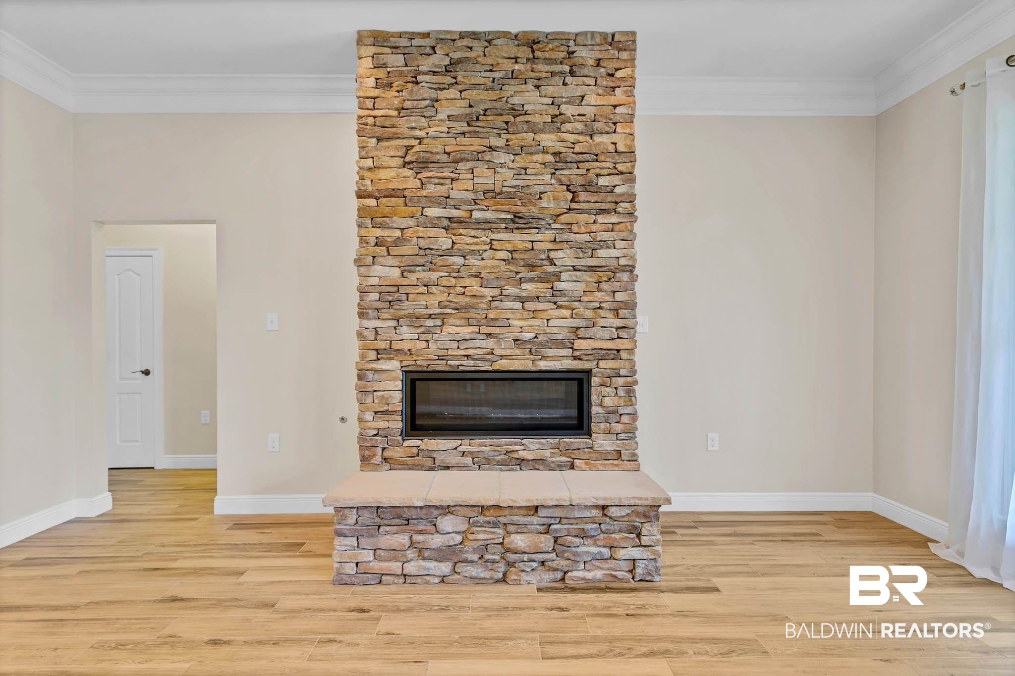 8145 Bay View Drive Foley, AL 36535 - Photo 11 of 81 Unfurnished living room featuring ornamental molding, wood finished floors, and a fireplace