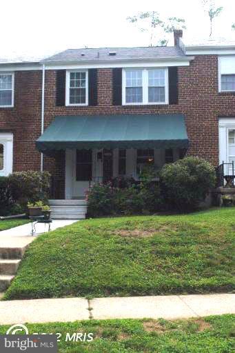 310 Stanmore Road Baltimore, MD 21212 - Photo 11 of 24 a front view of a house with a yard