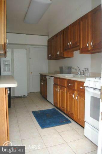 310 Stanmore Road Baltimore, MD 21212 - Photo 17 of 24 a kitchen with stainless steel appliances granite countertop a stove a sink dishwasher and a refrigerator