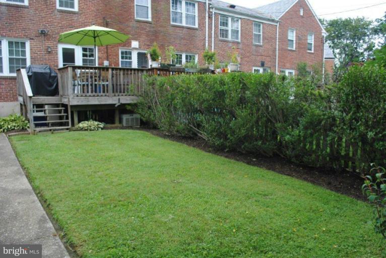 310 Stanmore Road Baltimore, MD 21212 - Photo 18 of 24 a view of a house next to a big yard and large trees