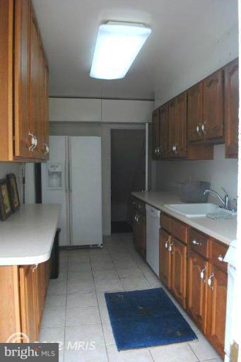 310 Stanmore Road Baltimore, MD 21212 - Photo 23 of 24 a kitchen with stainless steel appliances a sink a stove a refrigerator and cabinets