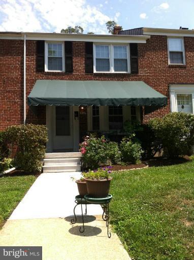 310 Stanmore Road Baltimore, MD 21212 - Photo 24 of 24 a front view of a house with a yard and potted plants