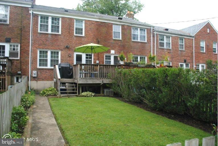 310 Stanmore Road Baltimore, MD 21212 - Photo 4 of 24 a view of a brick house with a yard patio and a table