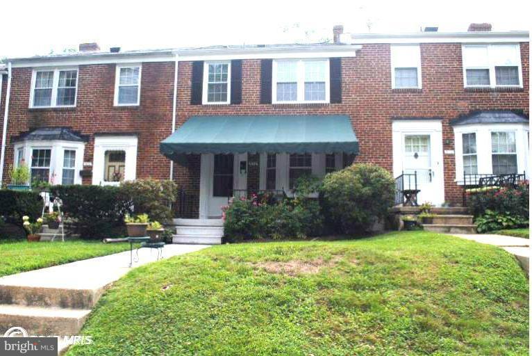 310 Stanmore Road Baltimore, MD 21212 - Photo 5 of 24 a view of a brick house with a yard and plants