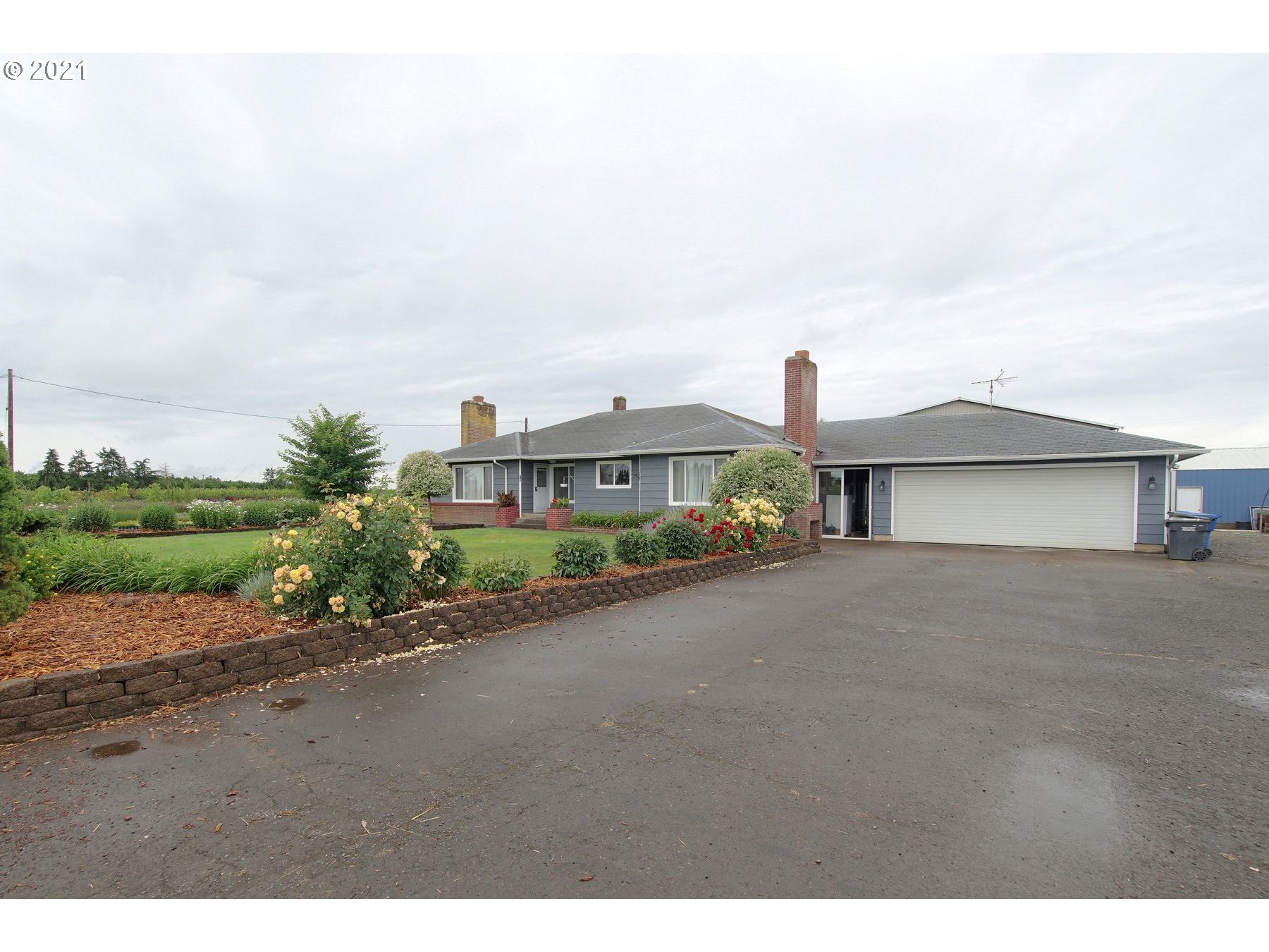 21451 River Road Northeast St. Paul, OR 97137 - Photo 2 of 32 a front view of a house with a yard and garage