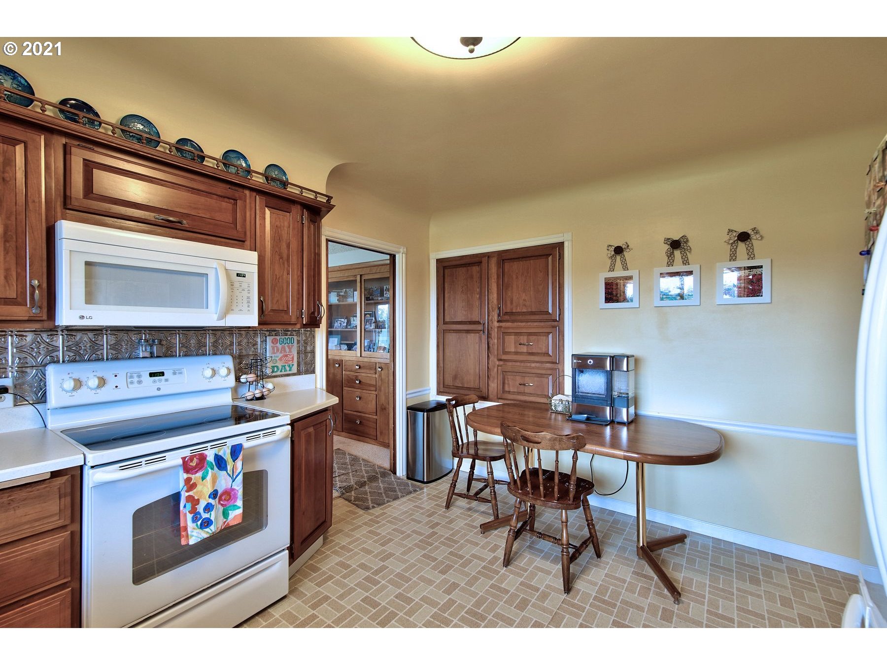 21451 River Road Northeast St. Paul, OR 97137 - Photo 11 of 32 a kitchen that has a cabinets and a stove with wooden table