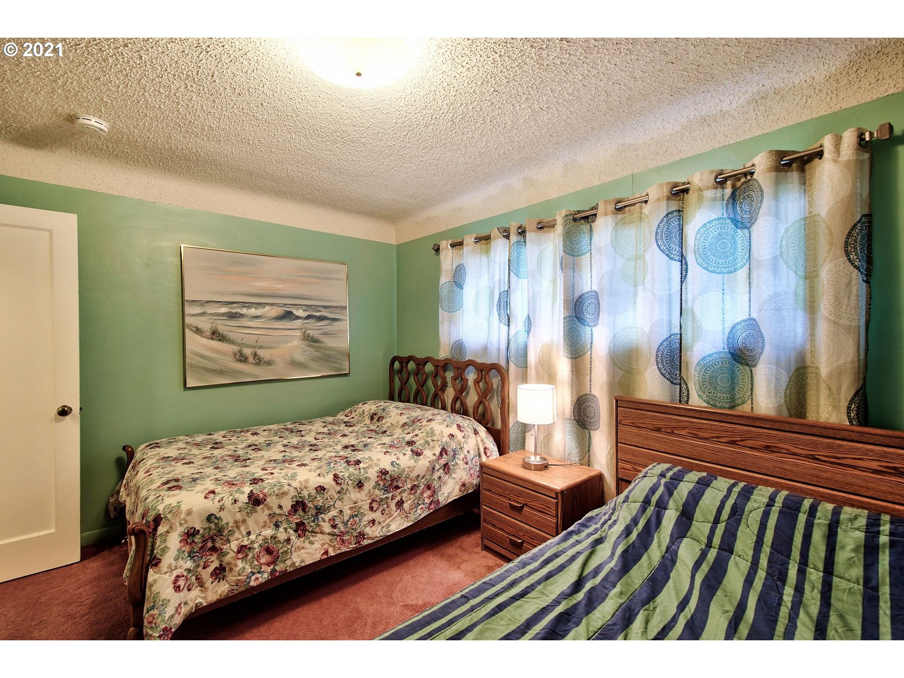 21451 River Road Northeast St. Paul, OR 97137 - Photo 17 of 32 a bedroom with a bed and a painting on the wall