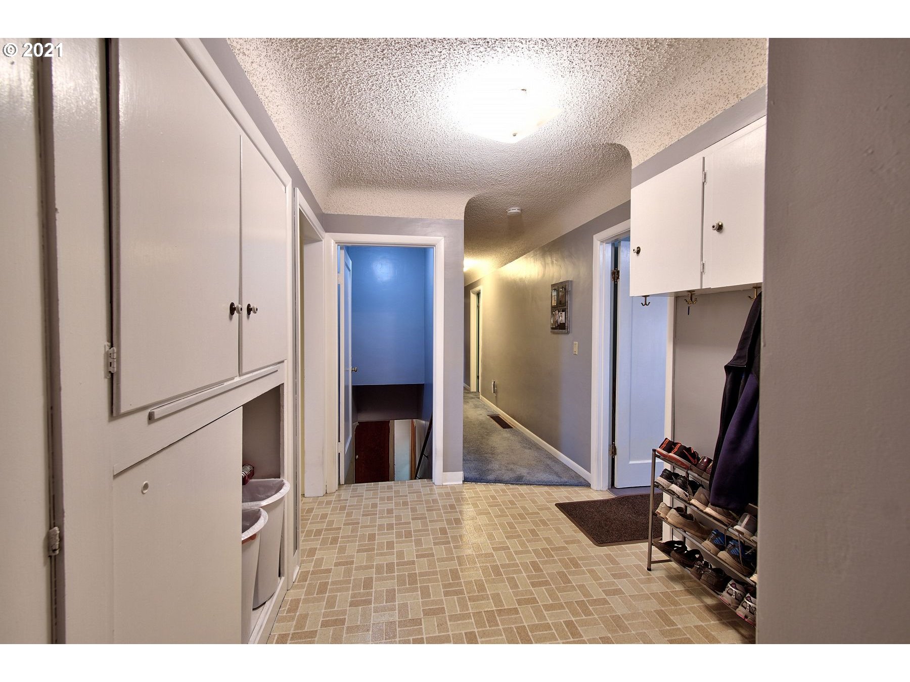 21451 River Road Northeast St. Paul, OR 97137 - Photo 22 of 32 a view of a hallway with a white stove top oven and kitchen island