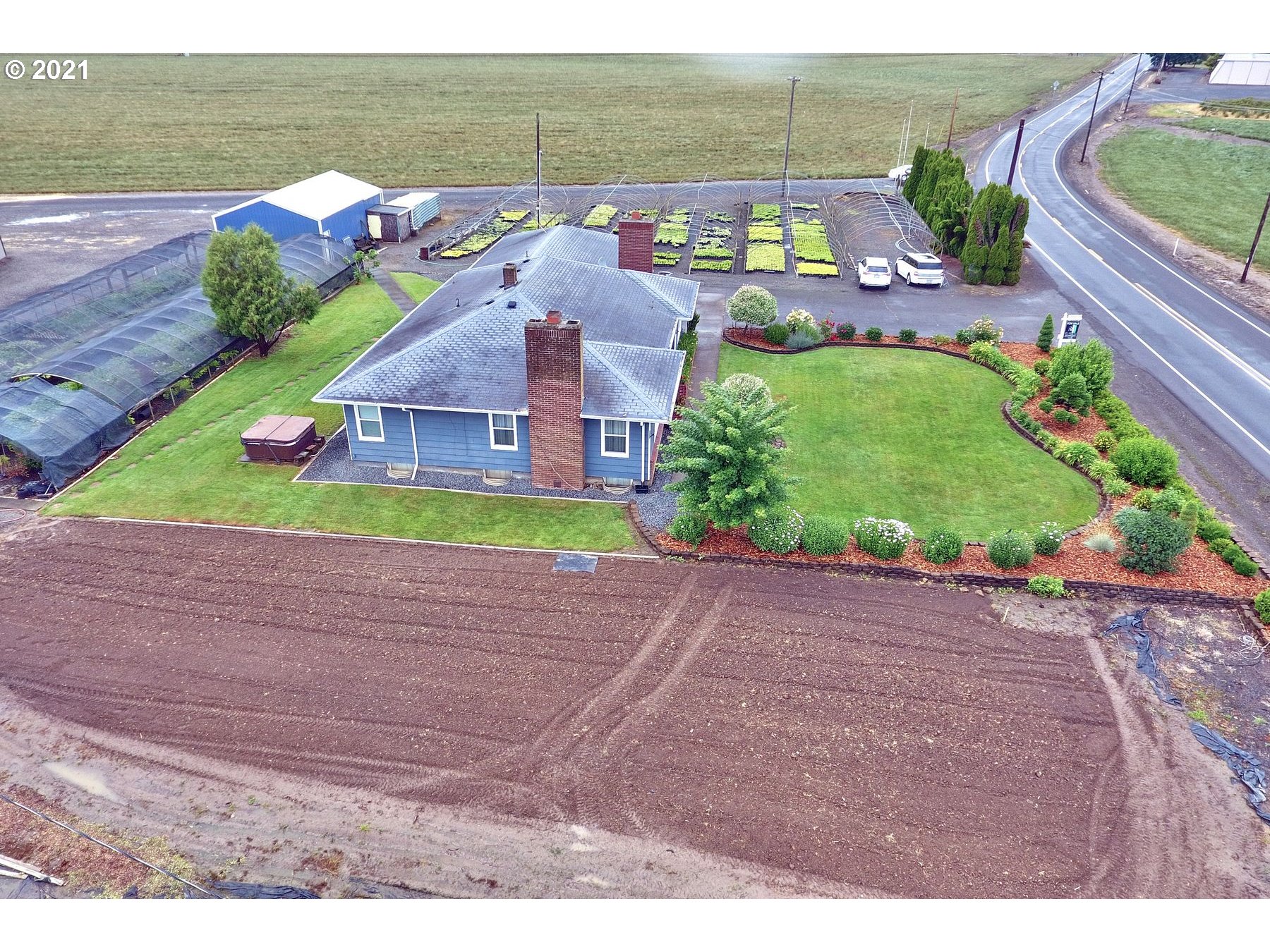 21451 River Road Northeast St. Paul, OR 97137 - Photo 28 of 32 a aerial view of a house with a yard and potted plants