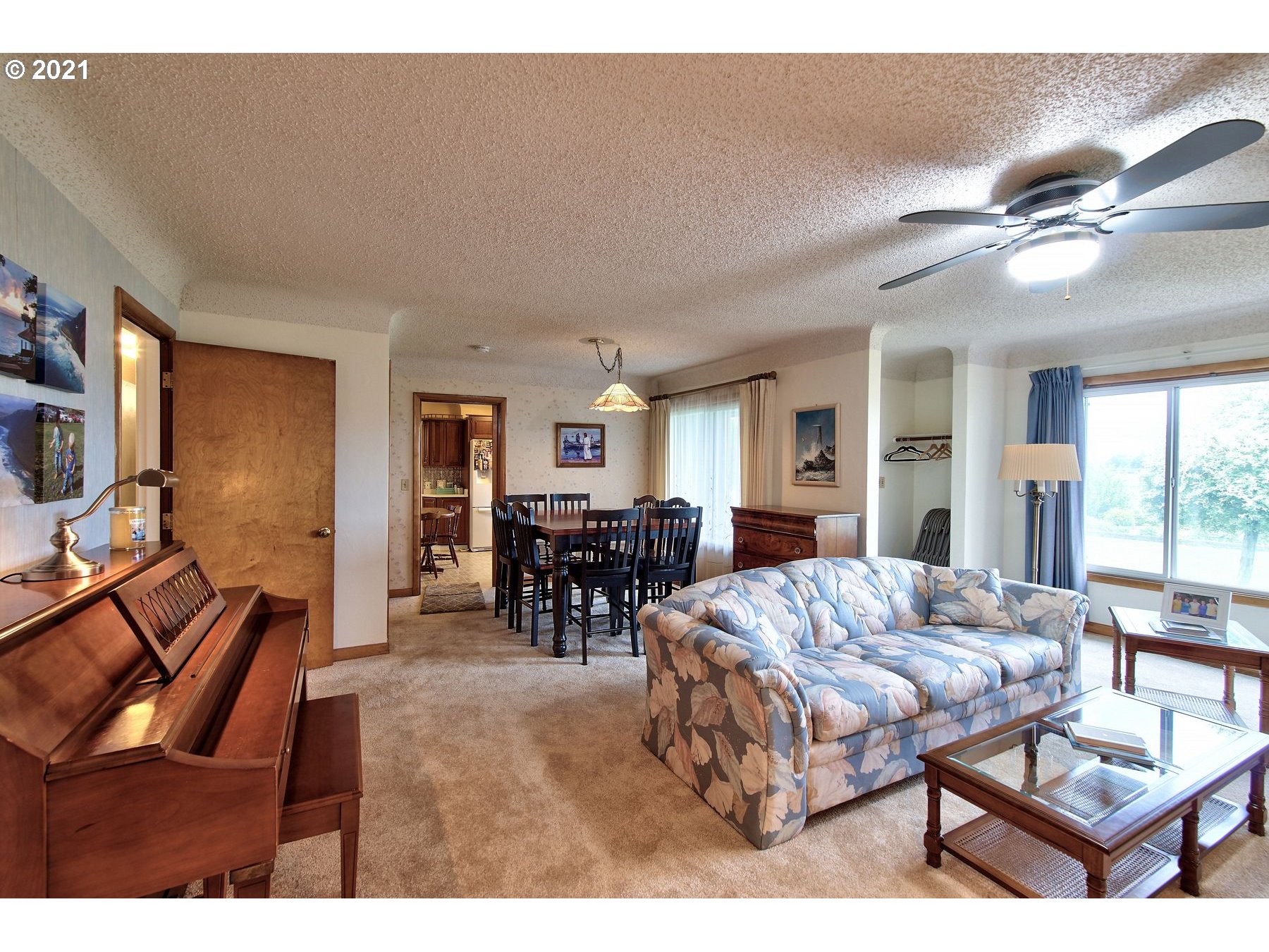 21451 River Road Northeast St. Paul, OR 97137 - Photo 6 of 32 a living room with furniture a flat screen tv and a refrigerator