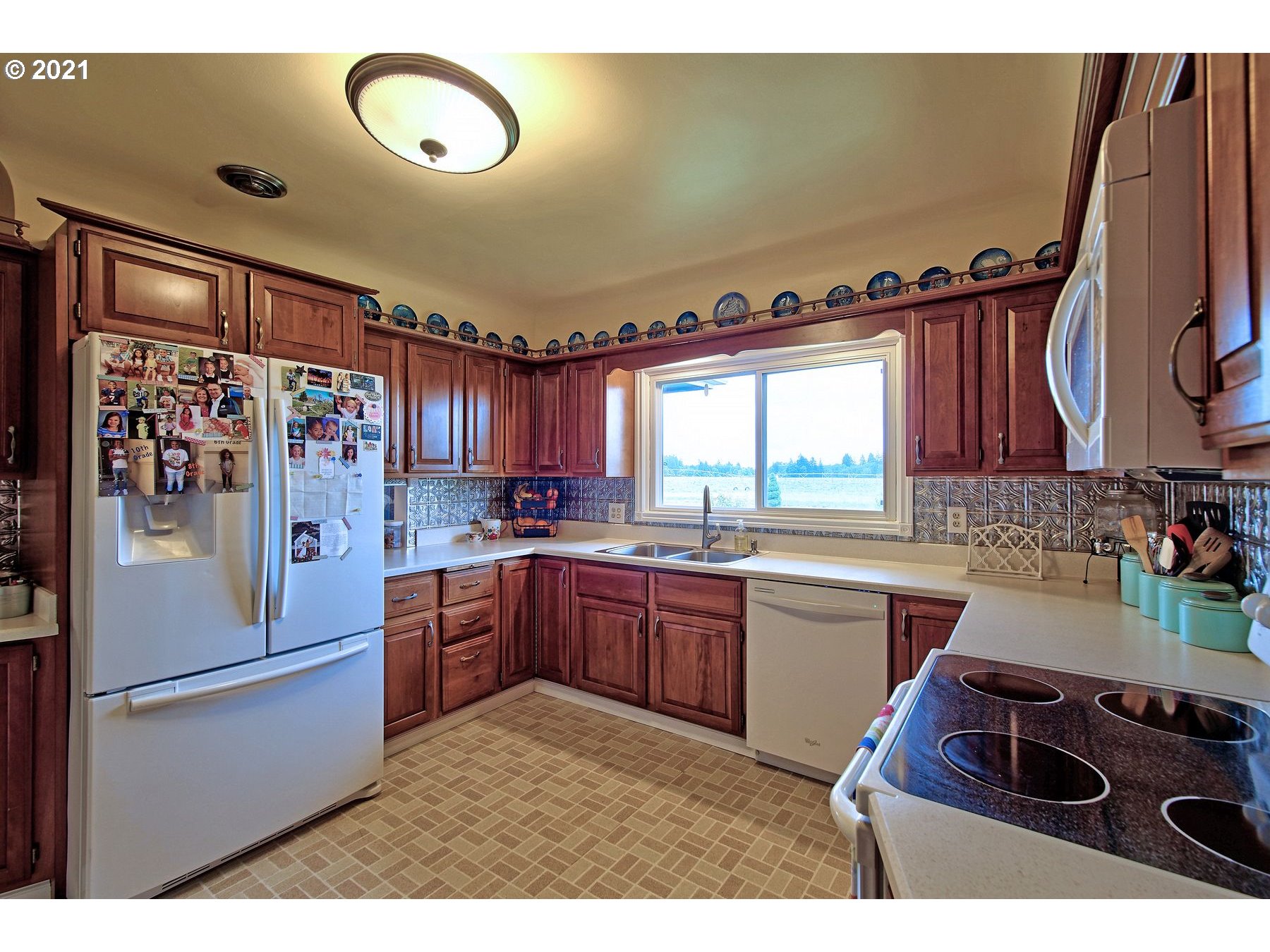 21451 River Road Northeast St. Paul, OR 97137 - Photo 9 of 32 a kitchen with a refrigerator and a stove