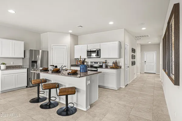 a kitchen with sink refrigerator and cabinets