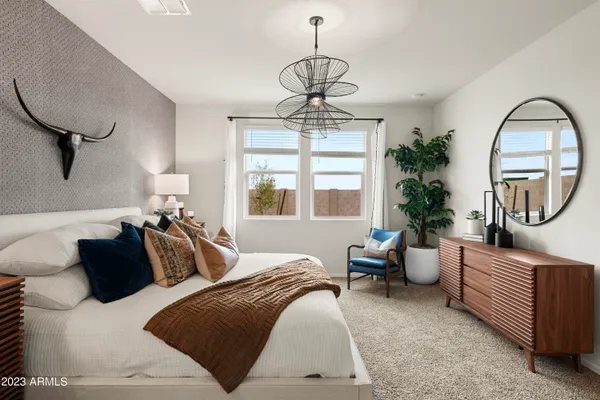 a bedroom with furniture and a window