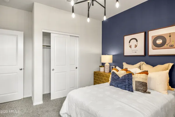 a bedroom with a bed and a chandelier