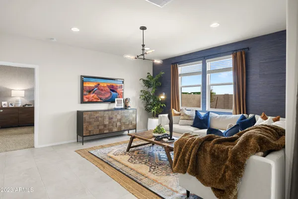 a living room with furniture a large window and a flat screen tv